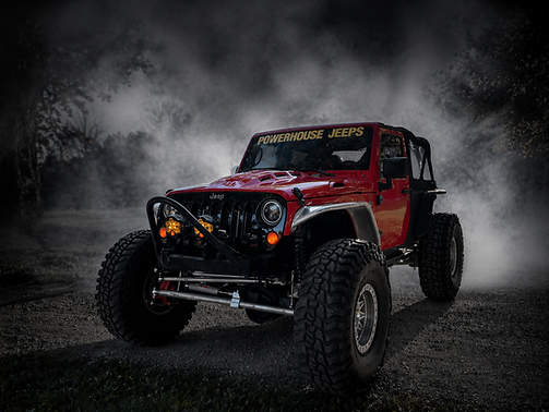 Red Jeep in smoky off-road scene.png