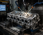 CNC machining a cylinder head in workshop.png
