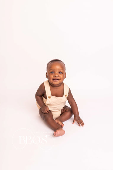Sitter session Essex image showing a baby surrounded by soft textures and natural light