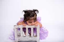 Sitter session Essex image showing a baby surrounded by soft textures and natural light