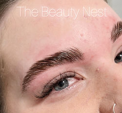 Eyebrow shaping and waxing, hybrid lash extensions on a client from Mahogany