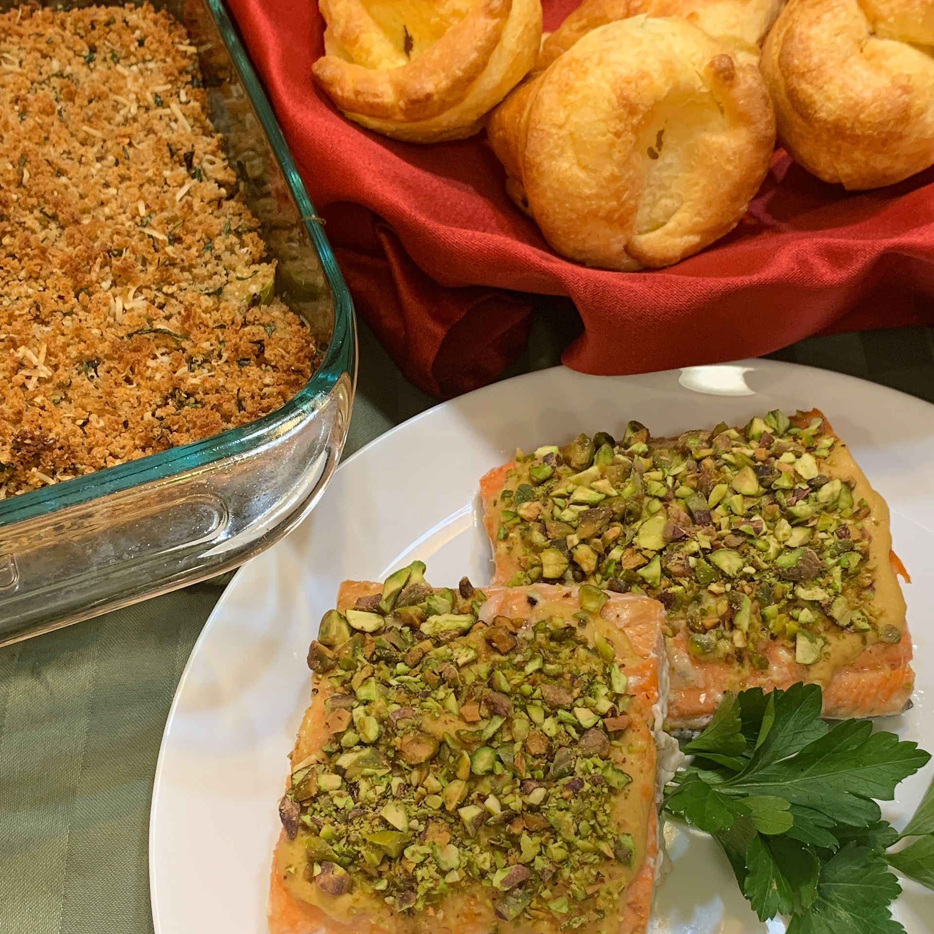dinner dishes waiting to be served.  salmon, gratin, popovers