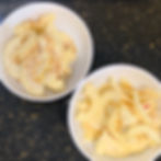 two white bowls of dehydrated apples on a counter