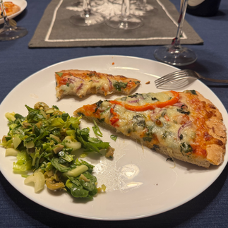 plate of partially eaten pizza and side salad 