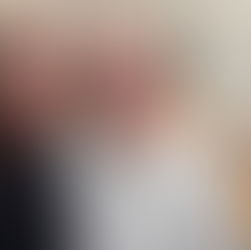 Tracy and Andrew standing in kitchen with plate of pizza on counter behind them