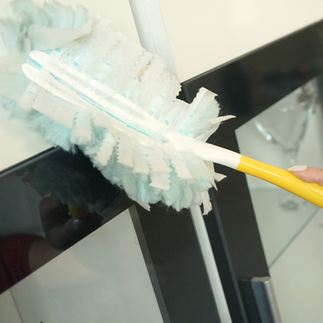 swifter duster dusting wooden cabinet doors