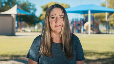 Upset woman sits at a local park