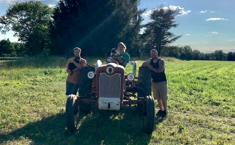 Tractor on a field in front of cellular tower