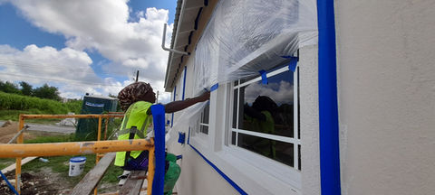Preparation for Total Wall Shot Blast application. Includes taping and masking windows.