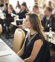 Young business woman at a conference or training.