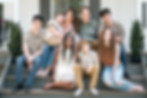 a large family sitting on porch steps