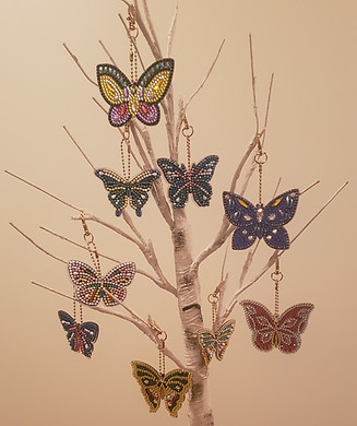 Nine Butterfly Diamond Painting Key Chains hanging on a Fake Birch Tree