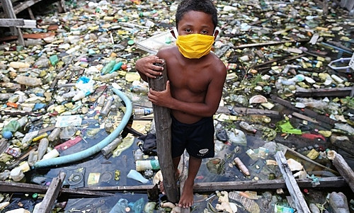 Boy from the riverside community of Educandos wears a face mask during a coronavirus pandemic in Manaus (AM).