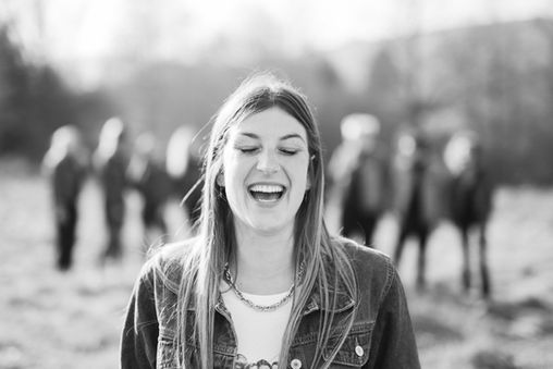 young woman bursting into laughter – moment of joy captured on the spot