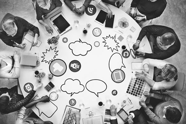 Group sitting around a table brainstorming ideas