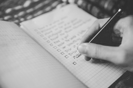 Someone writing a to do list to plan ahead