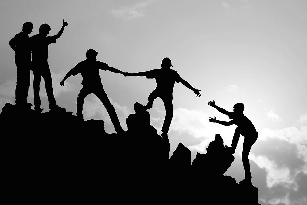 Different people climbing a mountain - lots of leaders
