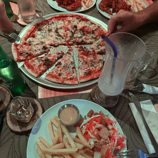Joys BBQ restaurant in Union Island Grenadines, pizza, spicy chicken wings, crudite vegetables, french fries, sauces