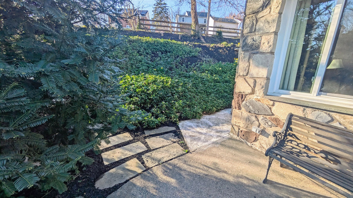 Backyard patio with outdoor seating and landscaped beds