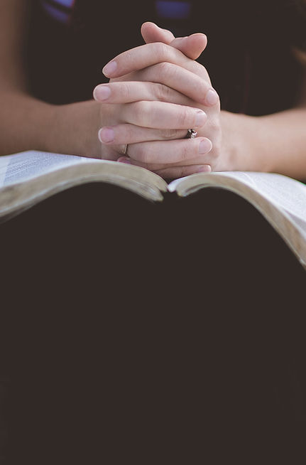 Woman in quiet prayer during devotional moment