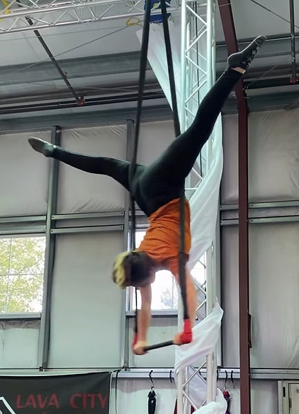 Adult trapeze student training at Lava City Cirque in Central Oregon