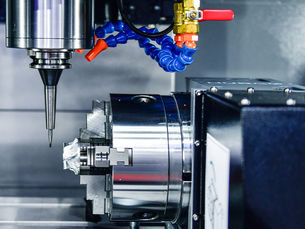 Close-up of a high-precision CNC lathe machining a metal part.