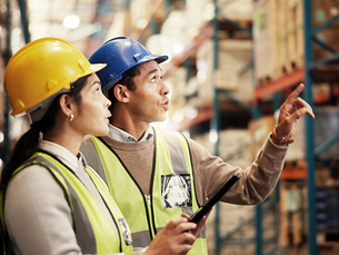 Warehouse managers overseeing turnkey manufacturing inventory and supply logistics.