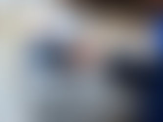 An operator using a digital HMI panel to monitor and adjust real-time process control parameters in a factory.