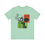 Thumbnail: Green t-shirt featuring overlapping cards with symbolic figures