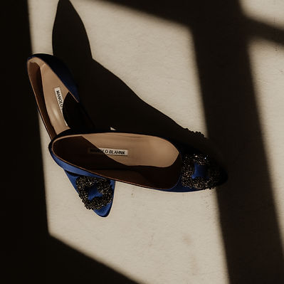 Bridal heels beside lace lingerie during a studio boudoir session