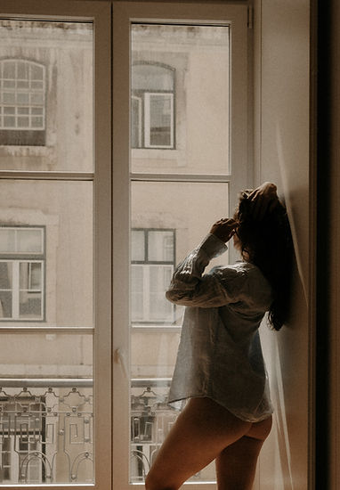 Cinematic boudoir portrait captured in a Portugal studio with floor-to-ceiling windows