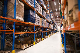 interior-large-distribution-warehouse-with-shelves-stacked-with-palettes-goods-ready-marke