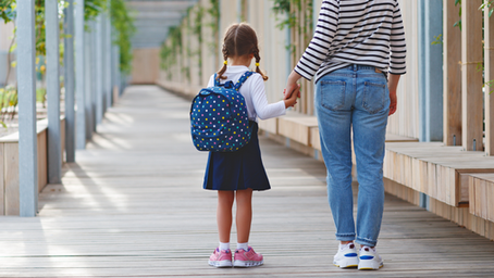 Mother taking her child to school