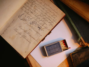 A notebook with cursive becoming more scribbled in it on a desk