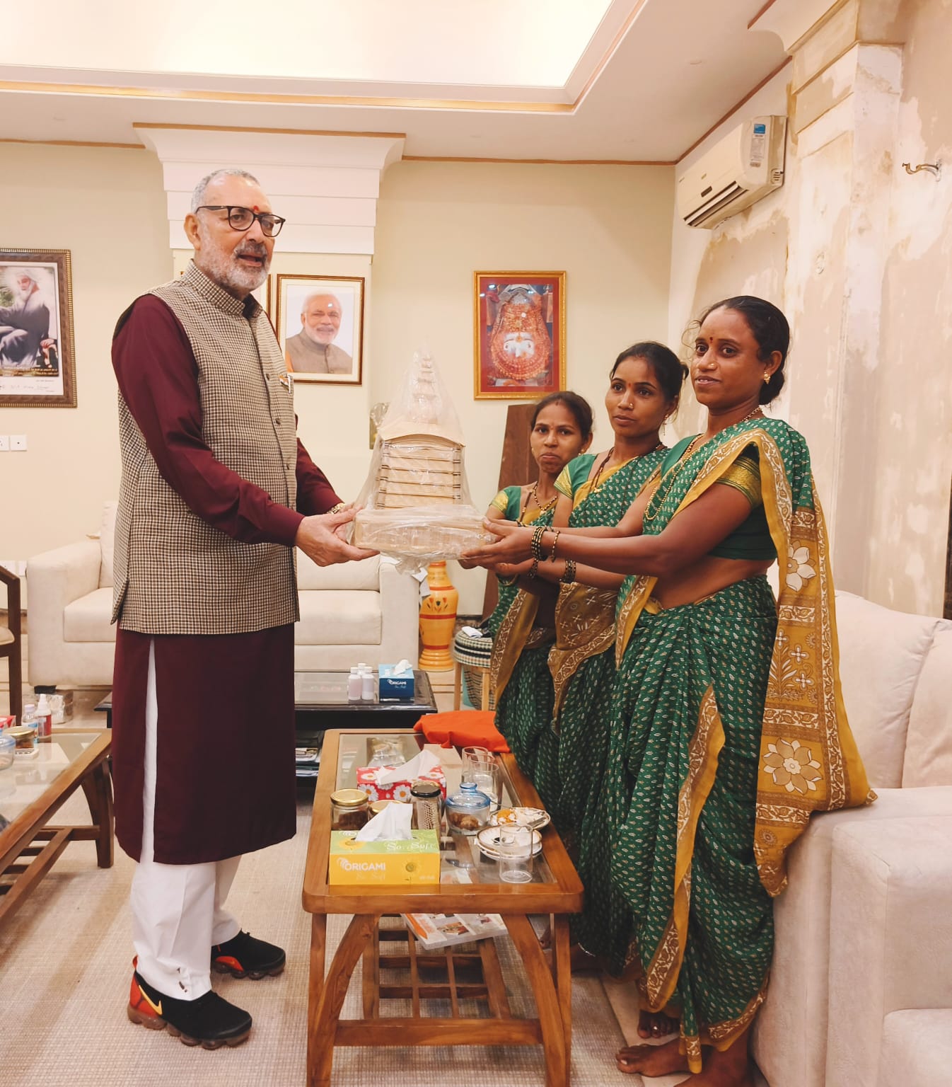 Dignitary receiving handcrafted bamboo memento from tribal women in office