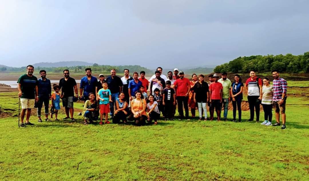 Visitors gathered in the lush green fields on eco-tourism experience