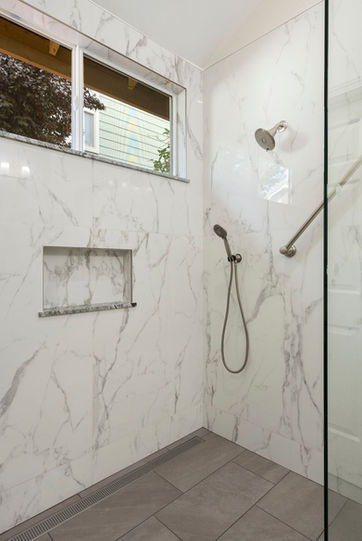 master bathroom remodel new shower fixed frameless clear glass enclosure recessed tile niche Delta Transitional Design BathSafety grab bars towel bars universal design Delta Faucet Kayra Valve Universal Showering Components showerhead handshower window in shower pony half wall Richards & Sterling Overtime Taupe porcelain tile Roca Tile Statuary Polished porcelain tile floors shower walls Miseno linear drain stainless finish