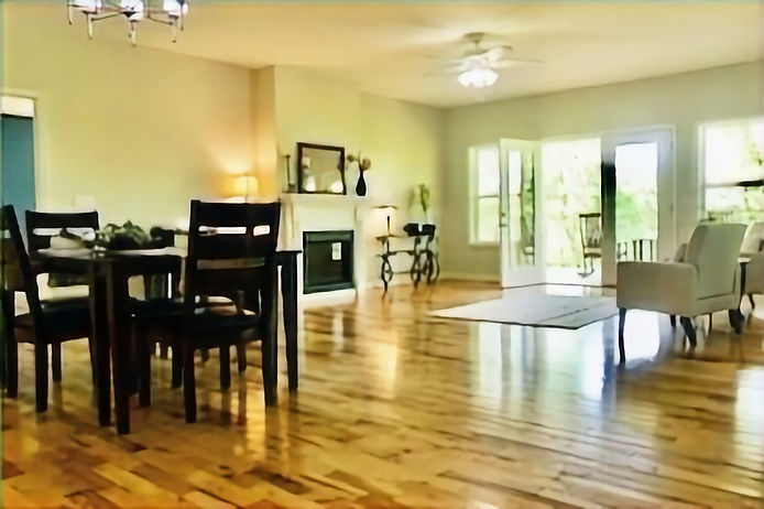 Long View of Fireplace Livingroom Showing Prominence of Black Dining Chairs_edited_edited.