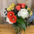 A colorful video featuring a floral arrangement with yellow, orange, and hot pink roses and assorted flowers.