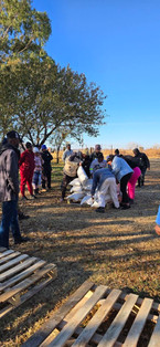 Employees lifting up feed bags to carry to pallets