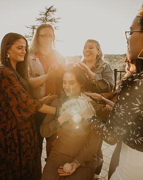 Friends sharing and receiving Reiki treatment in a tranquil setting in Sedona retreat