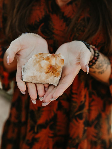 Close-up of hands holding a healing crystal, symbolizing energy balance and holistic wellness.