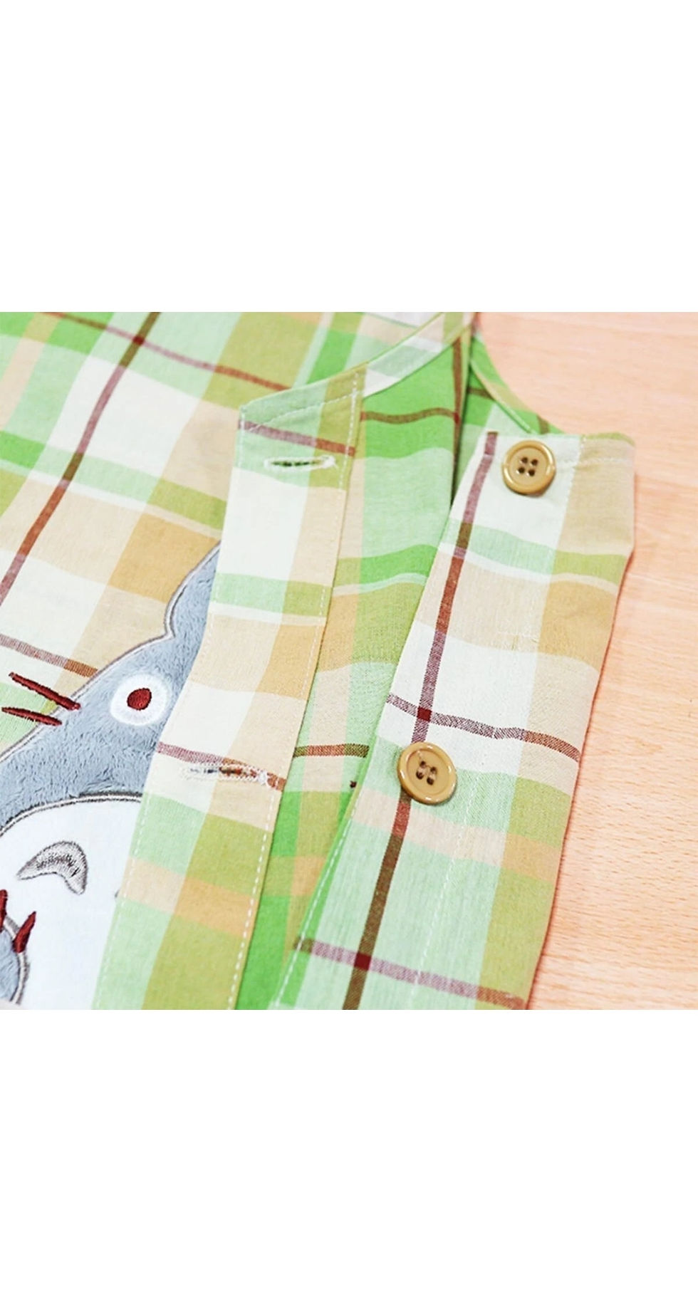 Thumbnail: Apron detail close-up - button fastening