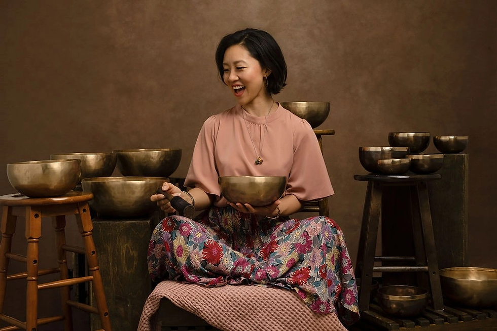 Harumi Gondo, surrounded by sound therapy bowls.