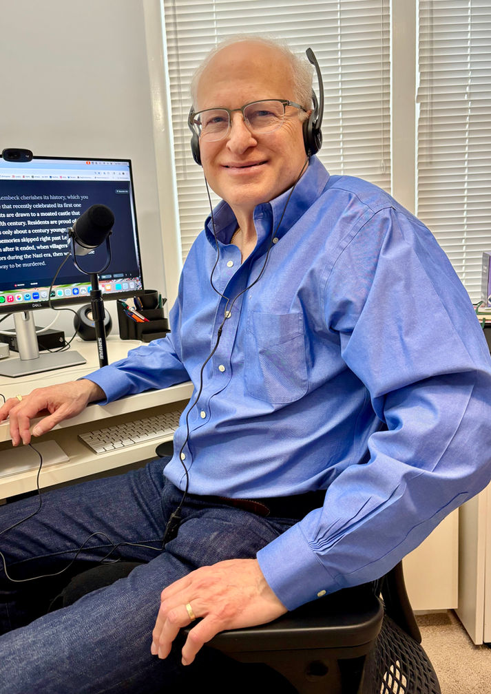 The author sitting at a workstation, recording the audiobook