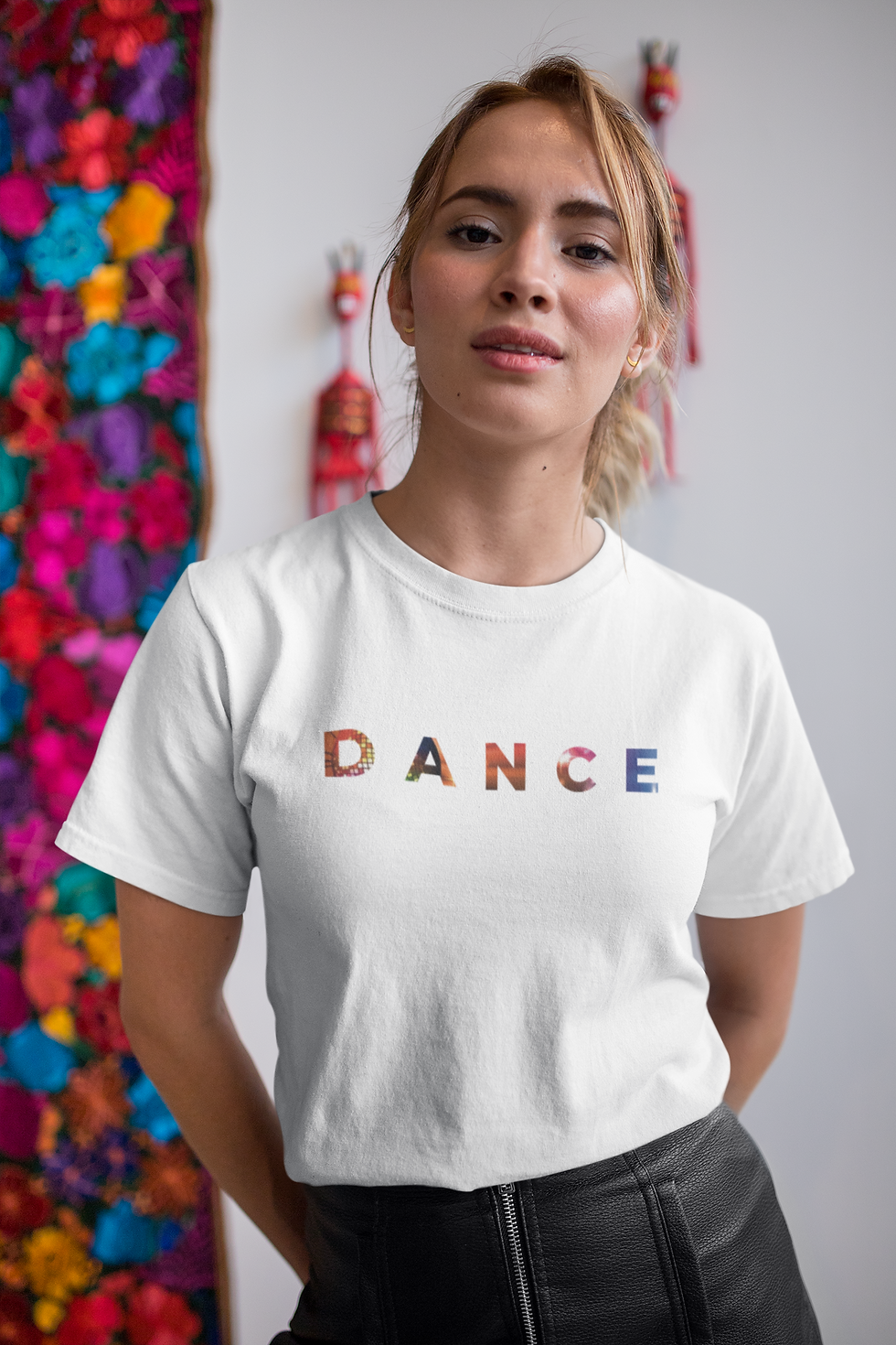 Thumbnail: woman wearing a white t shirt with the word Dance on the front in bright colours
