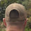 Thumbnail: Man wearing a sand coloured trucker cap from the rear