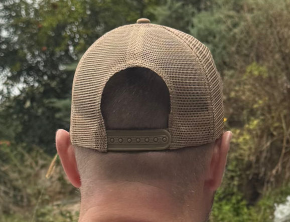 Man wearing a sand coloured trucker cap from the rear