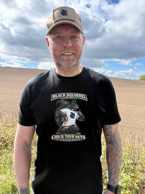 Man wearing a Black Squirrel Clothing Check your Nuts T shirt