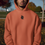 Thumbnail: Black man wearing an orange hoodie with a small black squirrel design on the chest
